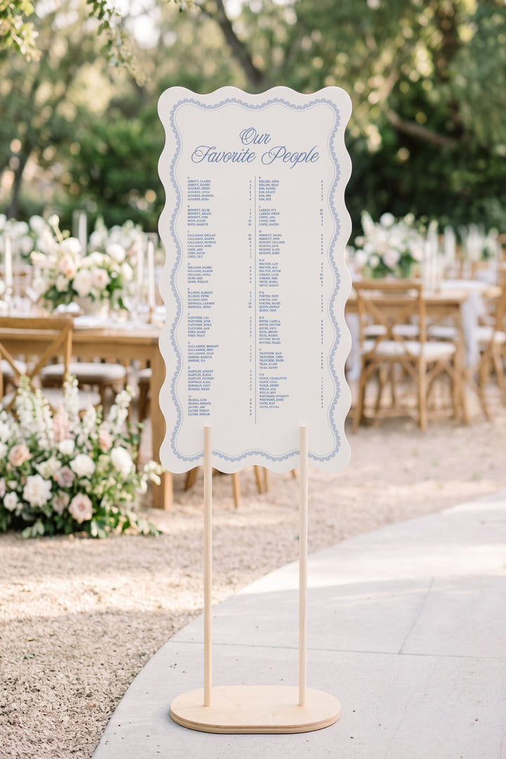 Powder blue wavy edge wedding seating chart with a lace border, guests listed A to Z with table numbers #shape_Wavy#color_Powder