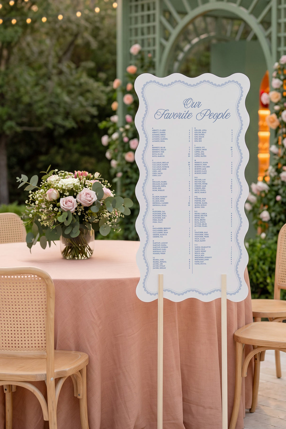 Powder blue wavy edge wedding seating chart with a lace border, guests listed A to Z with table numbers #shape_Wavy#color_Powder