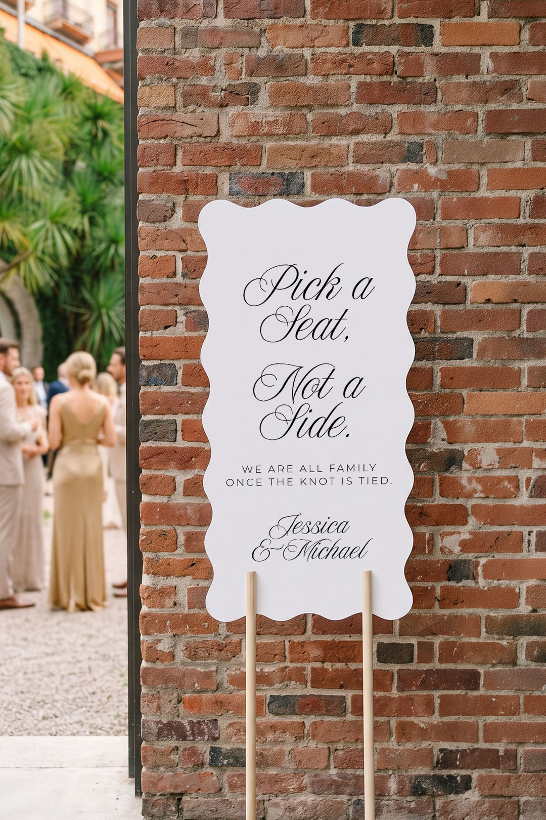 Wavy pick a seat sign on a wood stand against a brick wall at golden hour #shape_Wavy#size_Signature