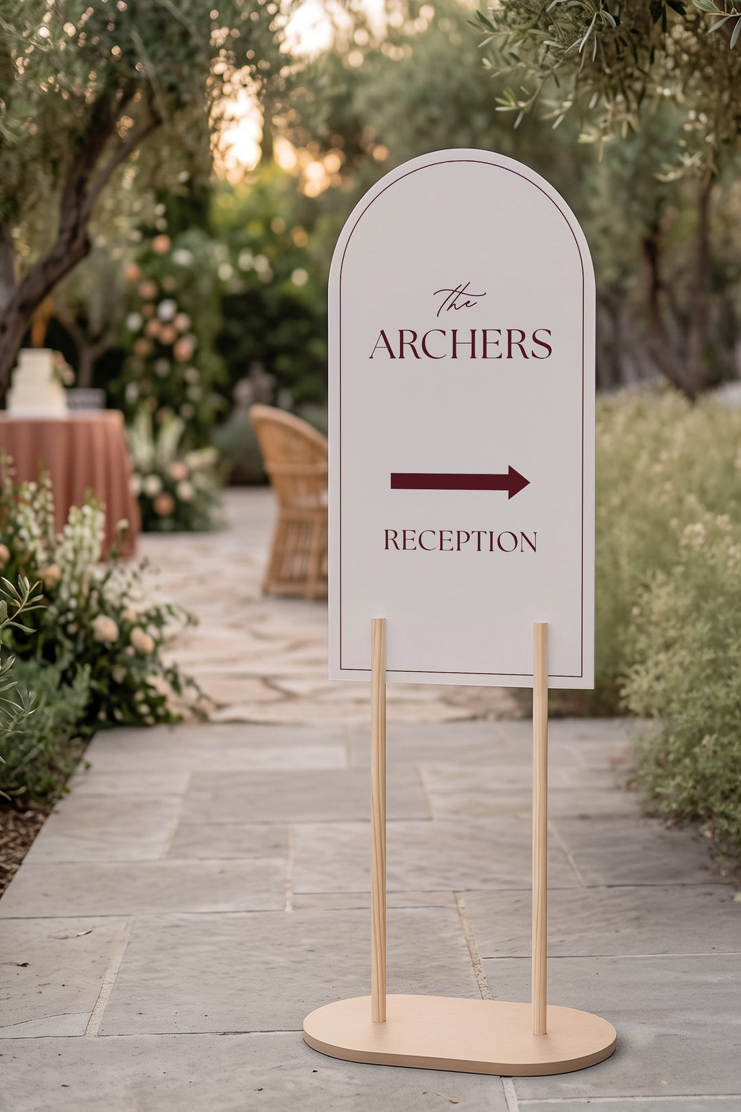 Linen off white arch reception directional sign on a stone terrace at golden hour #color_Linen