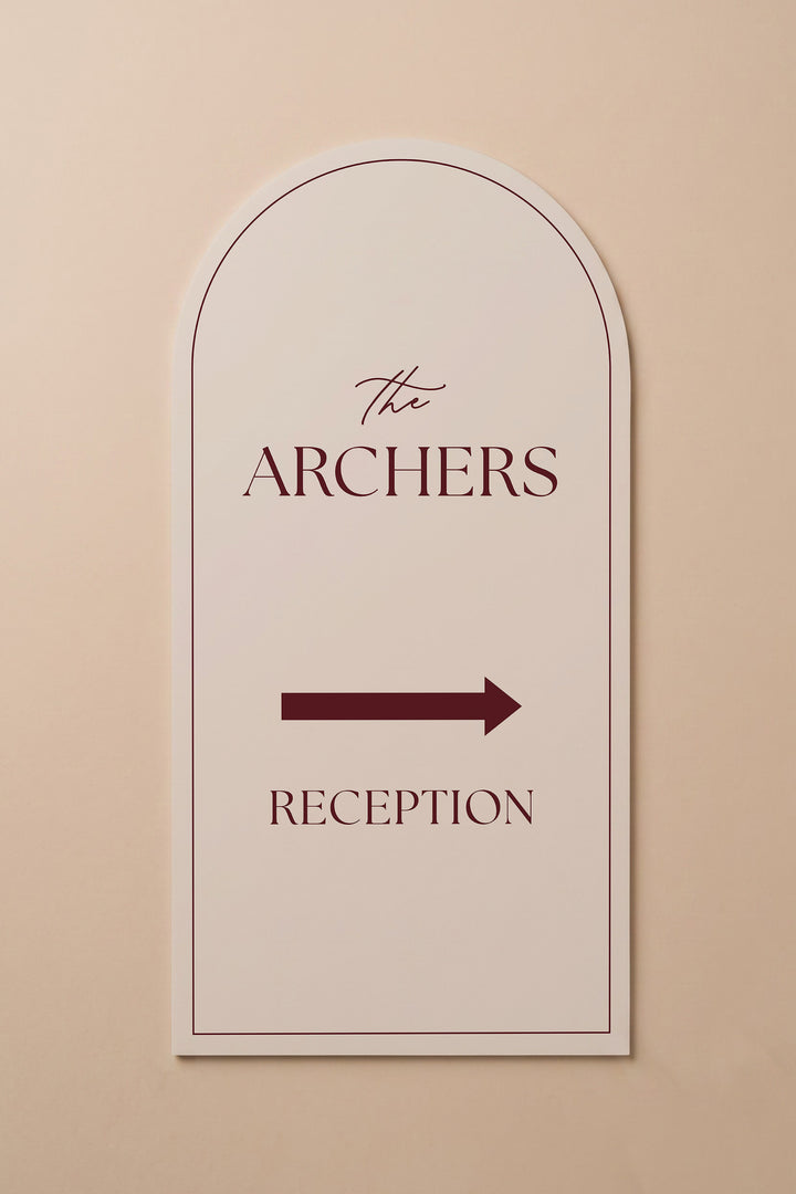 Linen off white arch reception directional sign shown flat against a warm neutral wall #color_Linen
