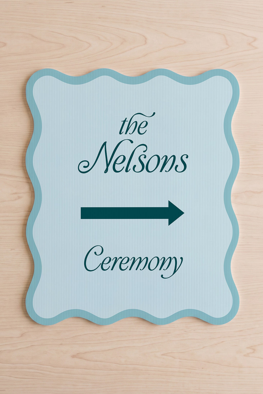 Salt Air blue wavy wedding directional sign shown flat, family name above the arrow #Color_Salt Air