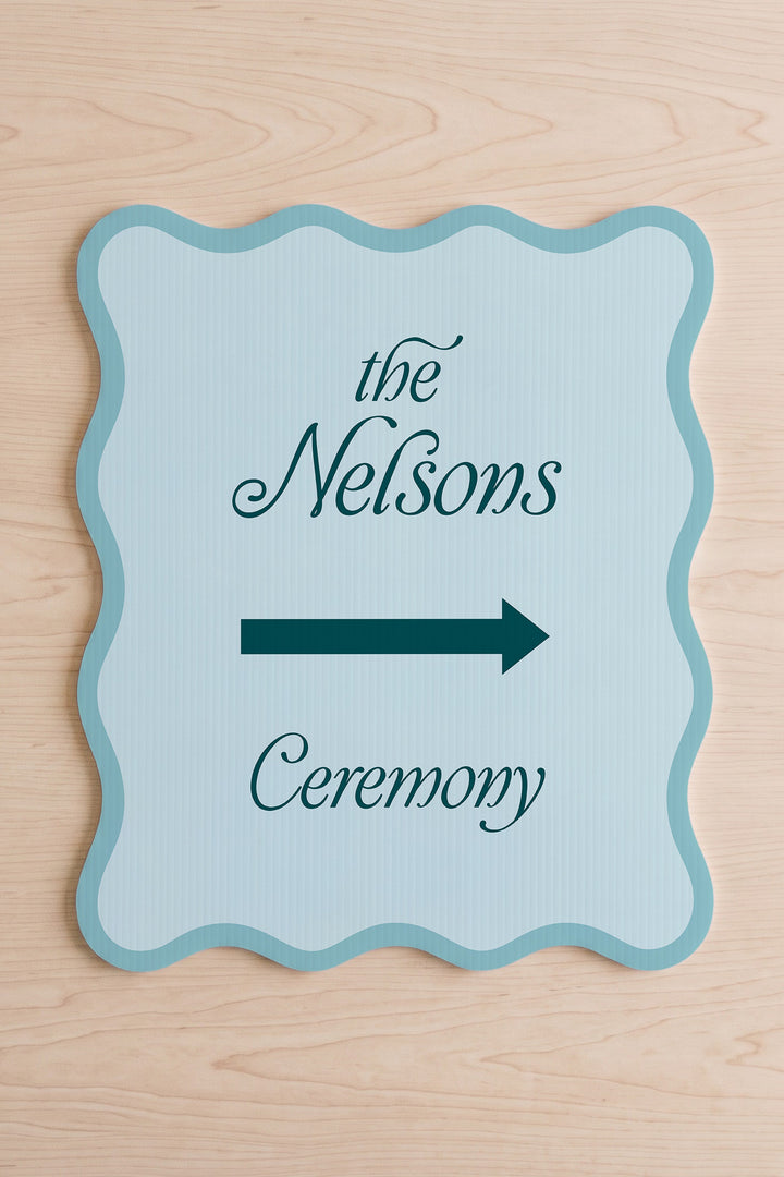 Salt Air blue wavy wedding directional sign shown flat, family name above the arrow #Color_Salt Air