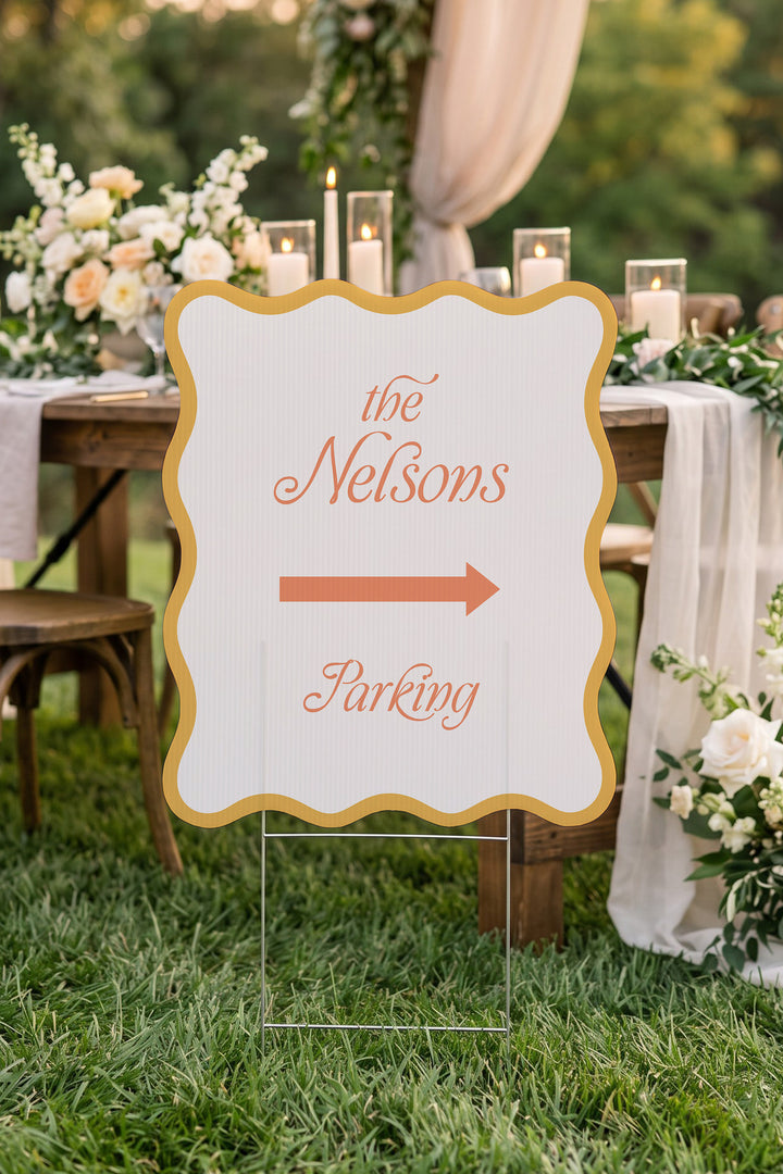 Sunkissed gold wavy wedding directional yard sign beside a candlelit reception table #Color_Sunkissed
