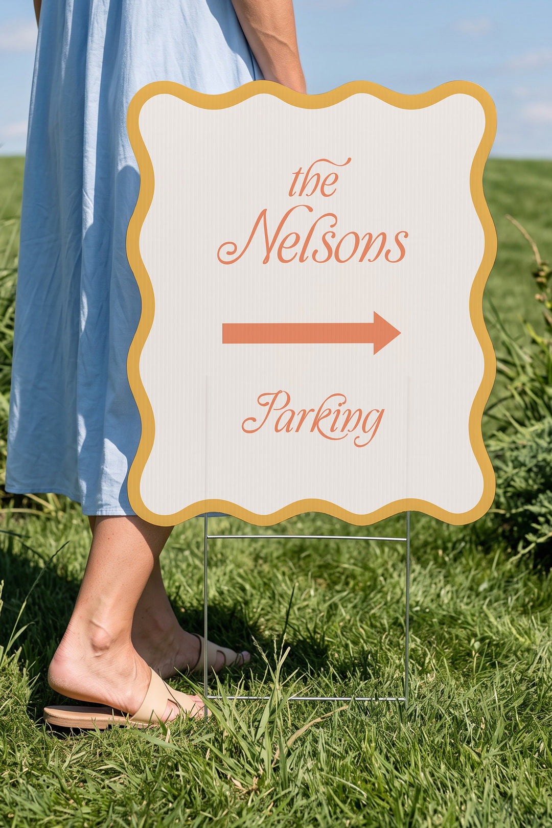 Sunkissed gold wavy wedding directional yard sign held beside a guest for scale #Color_Sunkissed