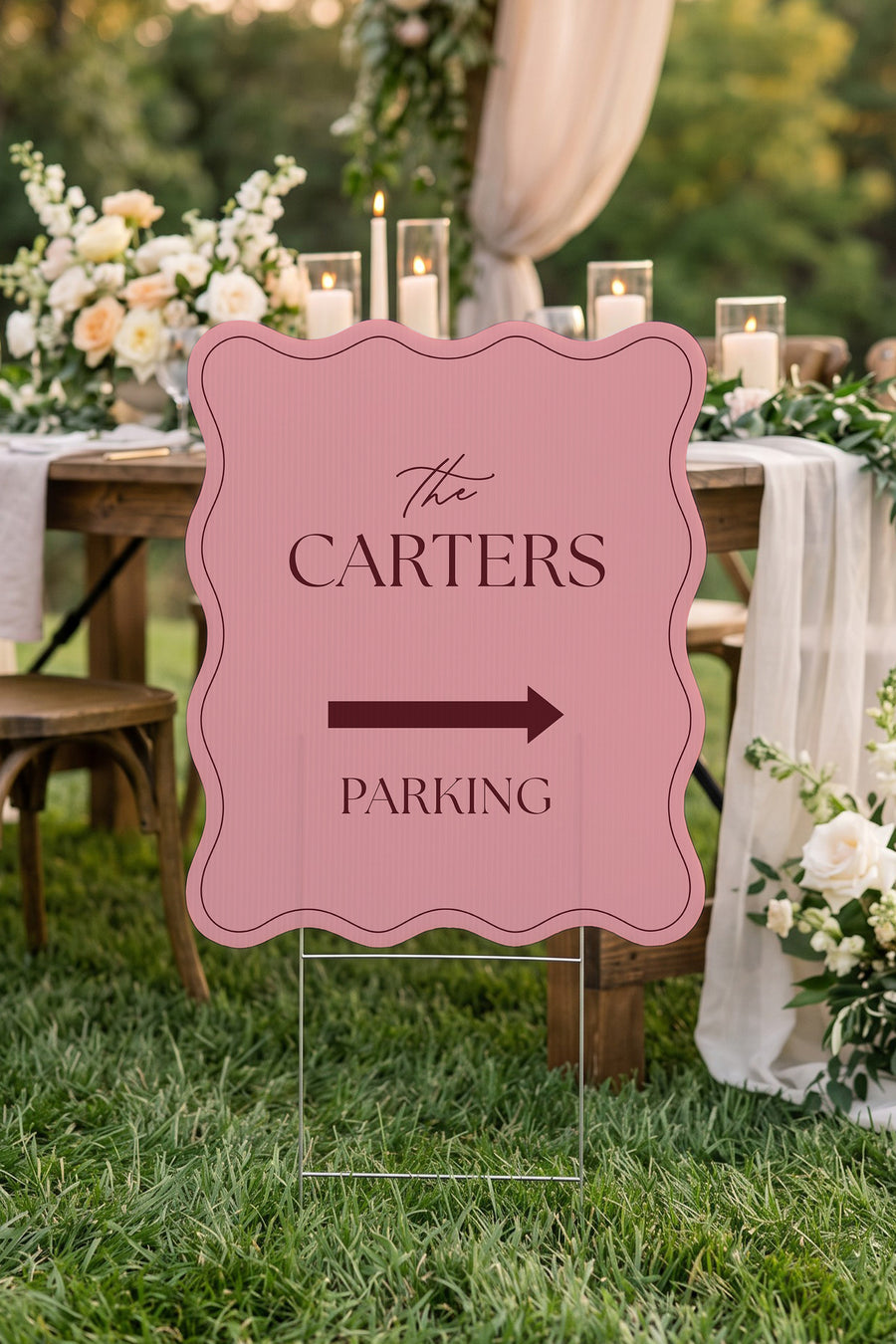Rosé pink wavy wedding directional yard sign staked beside a candlelit reception table #Color_Rosé