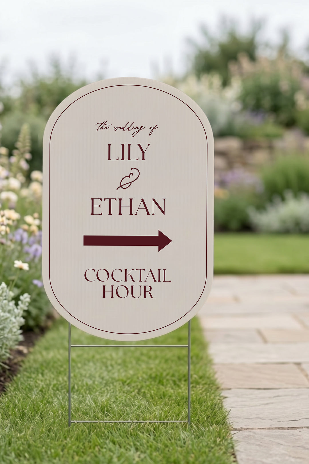 Linen off white pill wedding directional yard sign staked in a lawn beside a stone path #Color_Linen