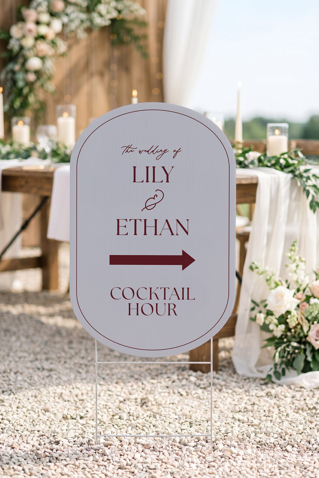 Pewter grey pill wedding directional yard sign on gravel beside a candlelit reception table #Color_Pewter