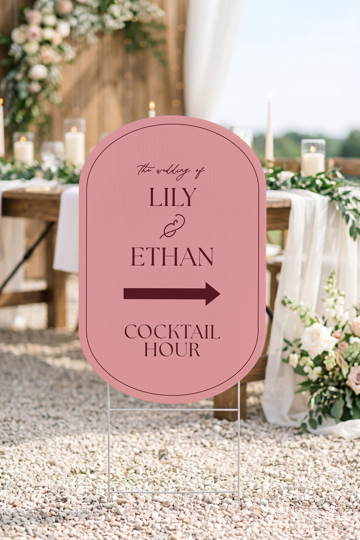 Rosé pink pill wedding directional yard sign on gravel beside a candlelit reception table #Color_Rosé