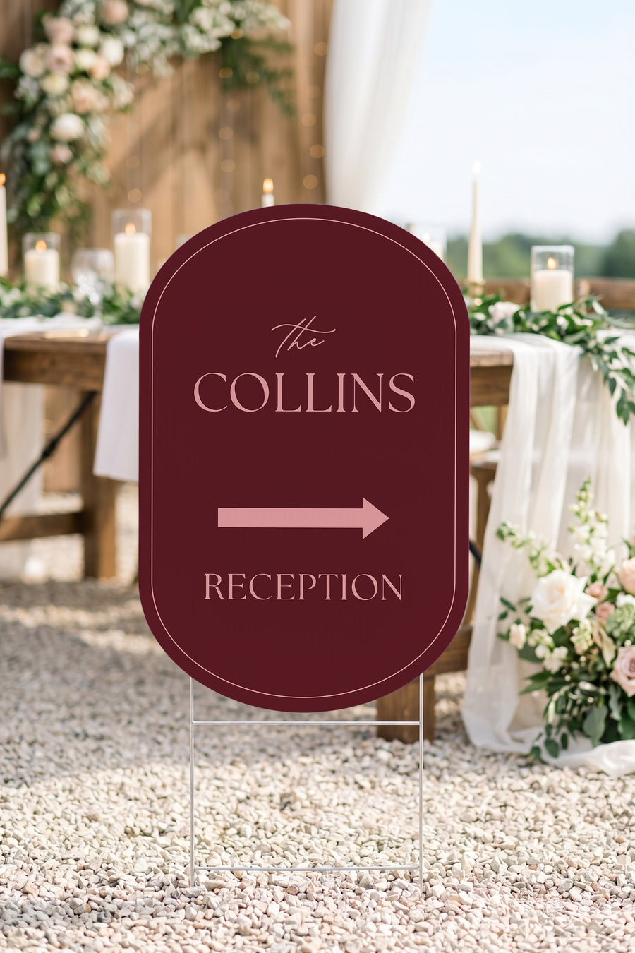 Merlot pill wedding directional yard sign on gravel beside a candlelit reception table #Color_Merlot