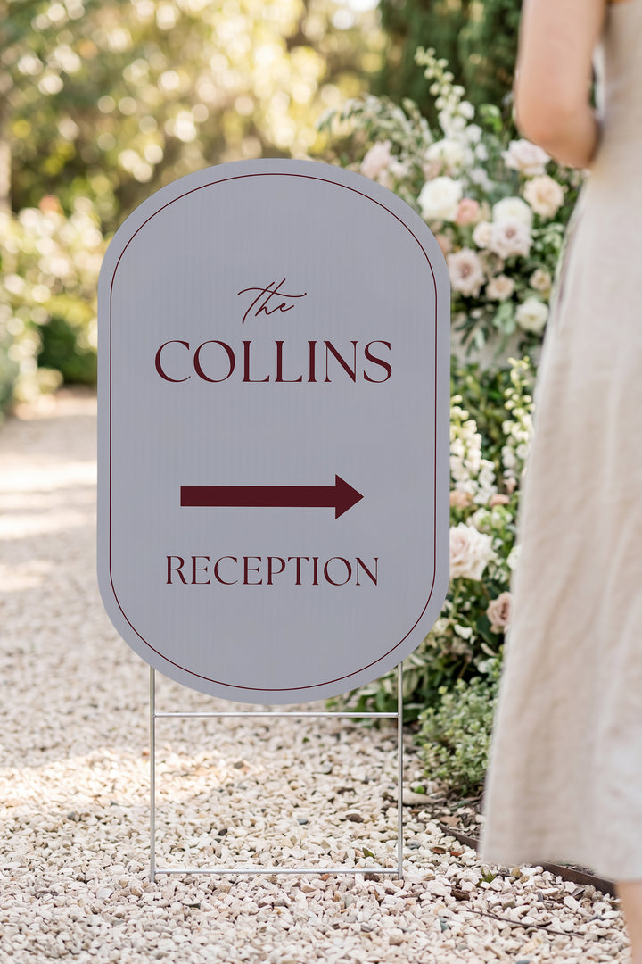 Pewter grey pill wedding directional yard sign in a garden beside a flower arch #Color_Pewter